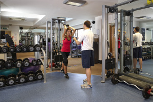 Woman exercising in free weights are at Wren's Club